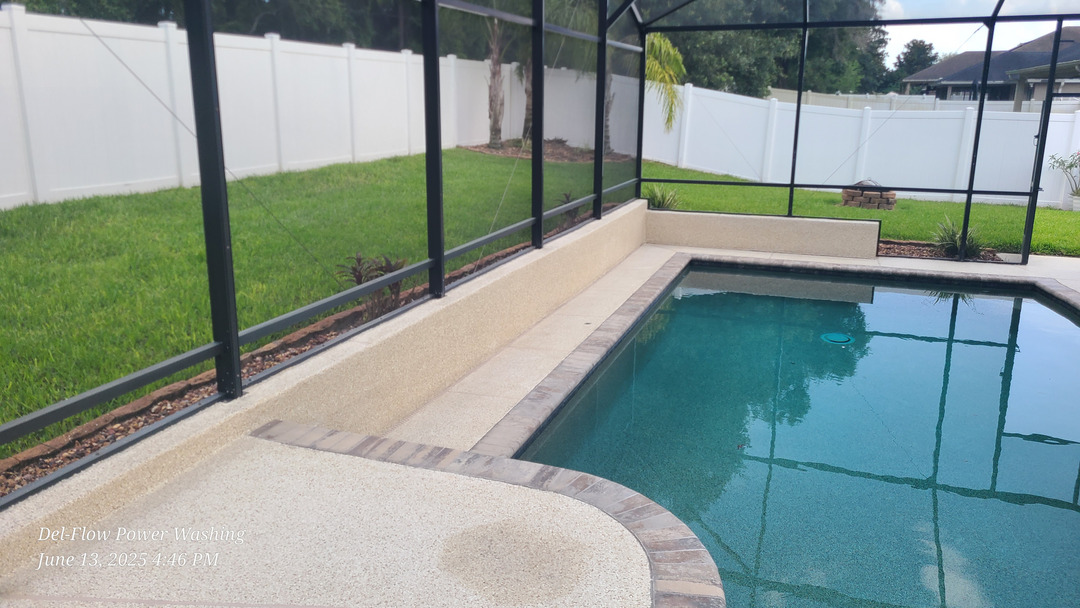 del-flow power washing cleaning a pool deck and surrounding areas with focus on concrete and tile surfaces