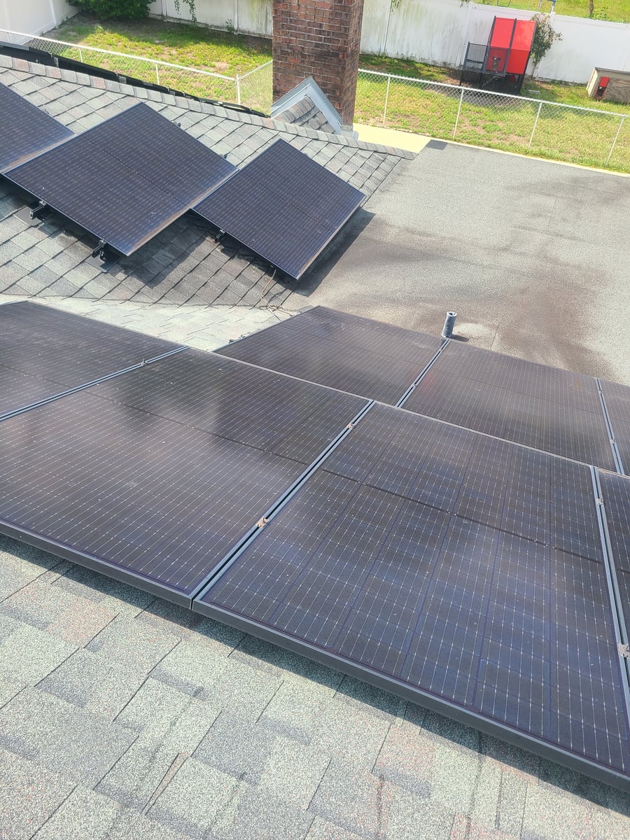 Solar panel cleaning with purified water on residential rooftop