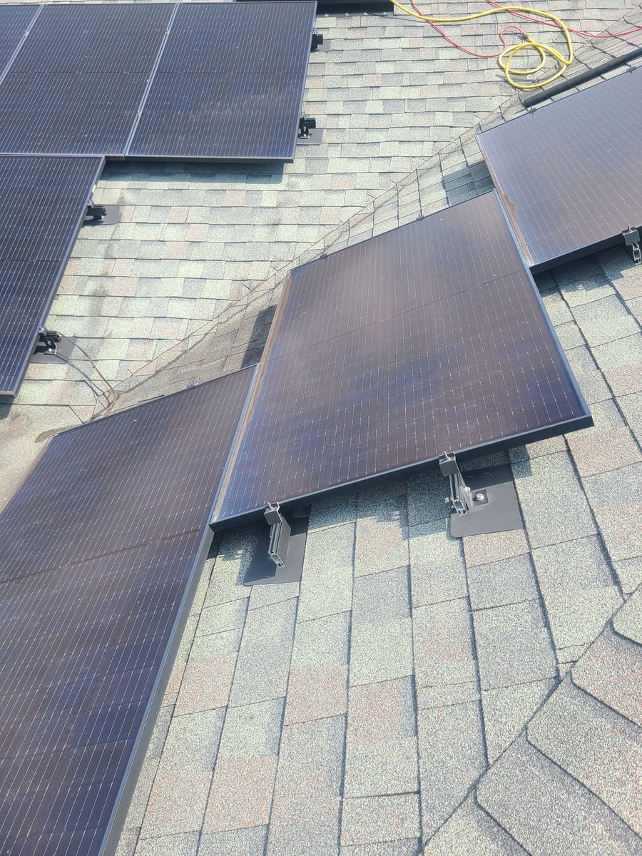 Solar panel cleaning with purified water on residential rooftop