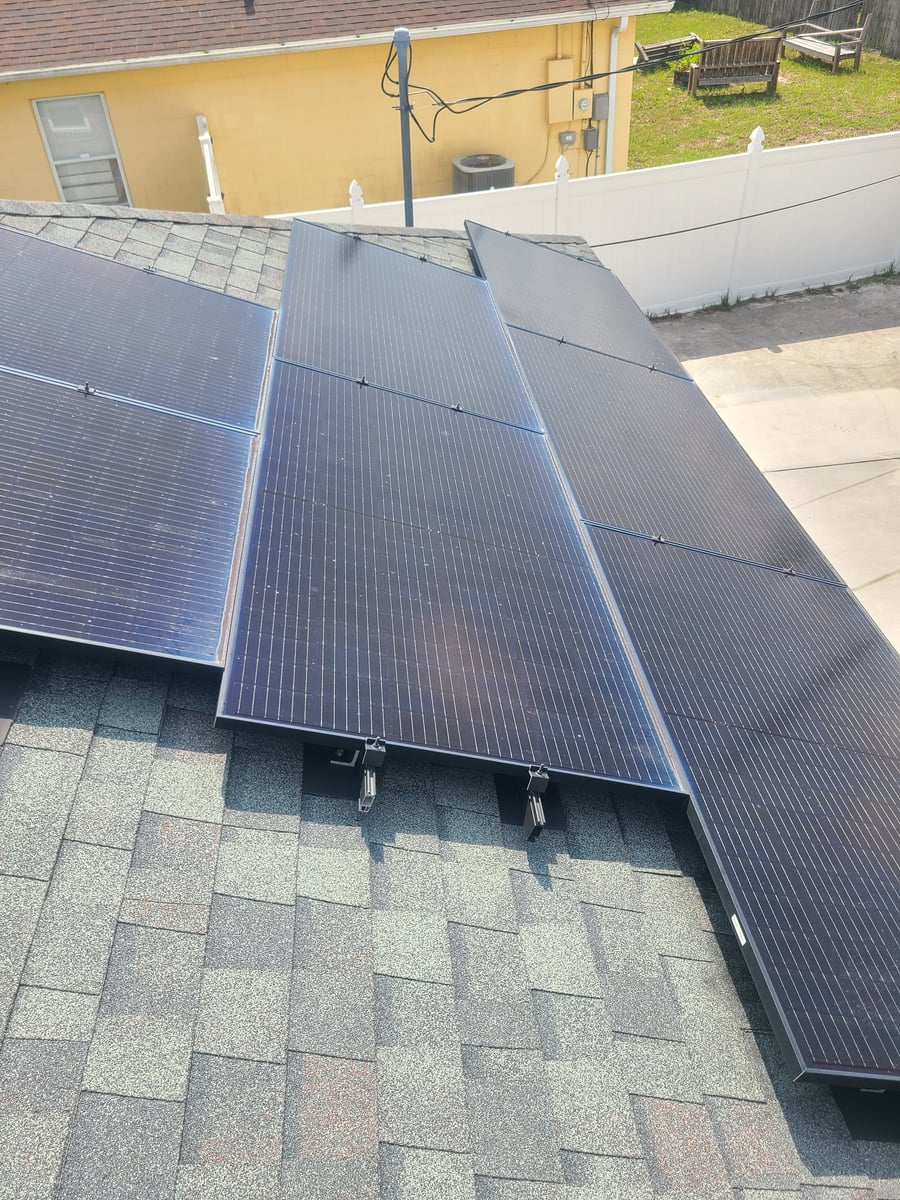 Solar panel cleaning with purified water on residential rooftop