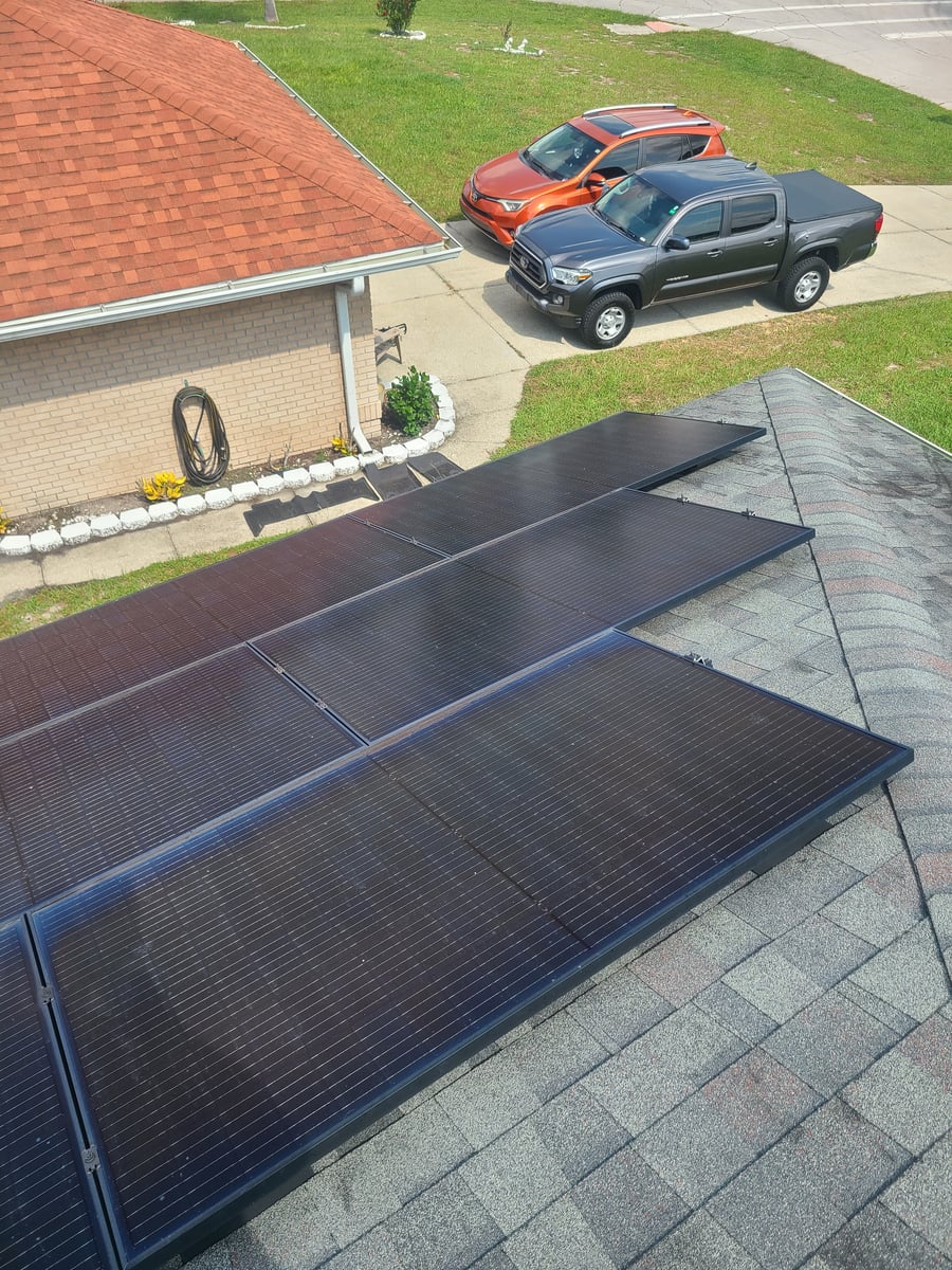 Solar panel cleaning with purified water on residential rooftop