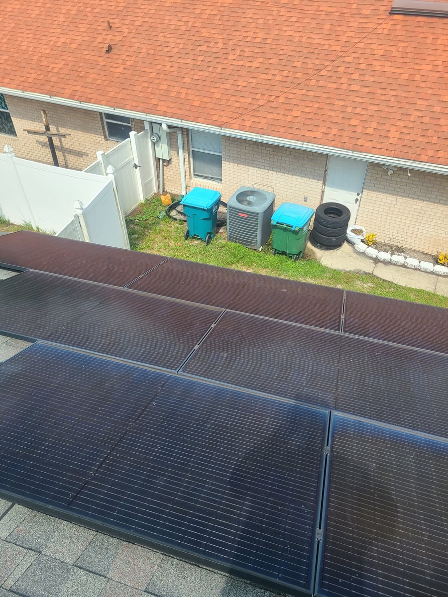 Solar panel cleaning with purified water on residential rooftop