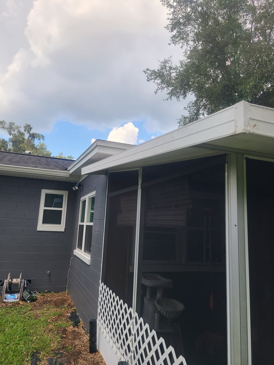 Exterior house washing and gutter cleaning with debris removal