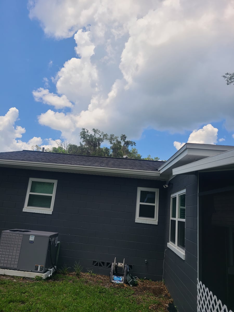 Exterior house washing and gutter cleaning with debris removal